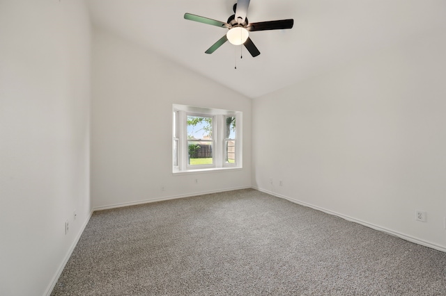 carpeted spare room featuring a ceiling fan, baseboards, and vaulted ceiling