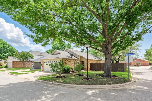 view of front of home with driveway, brick siding, and an attached garage