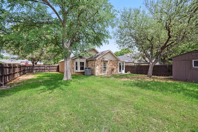 back of property with central AC unit, brick siding, a shed, and an outdoor structure
