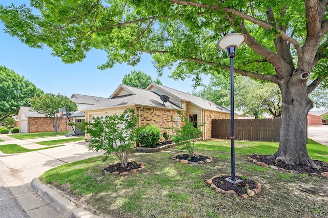 view of front of home featuring fence, brick siding, an attached garage, and concrete driveway