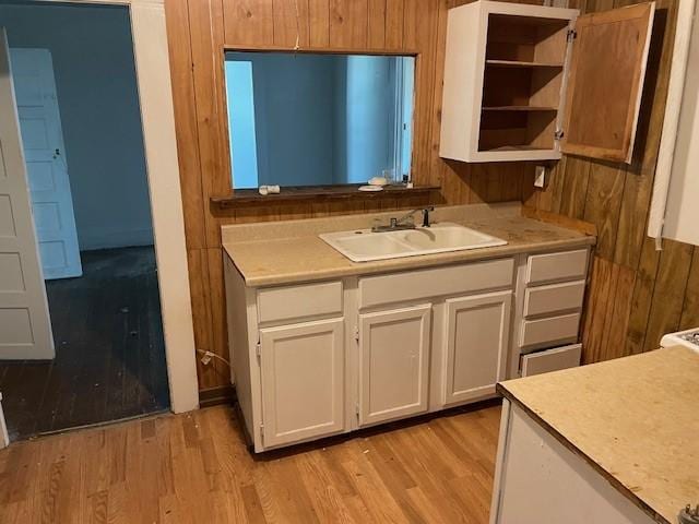 100 E Hill St, Woodson, TX 76491 - kitchen with a sink, light wood finished floors, light countertops, white cabinetry, and open shelves
