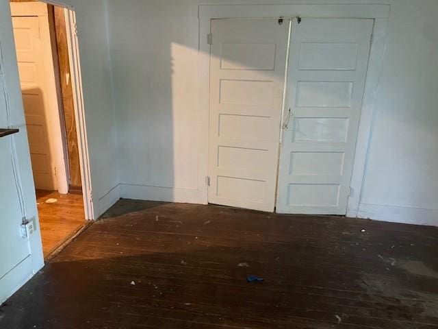 100 E Hill St, Woodson, TX 76491 - unfurnished bedroom featuring wood-type flooring and baseboards