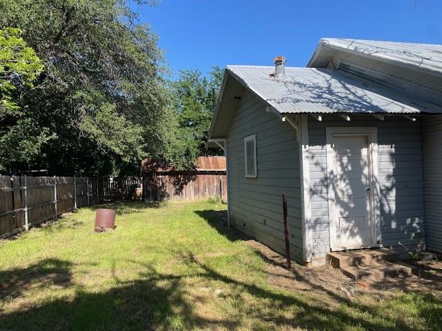 100 E Hill St, Woodson, TX 76491 - view of property exterior featuring metal roof