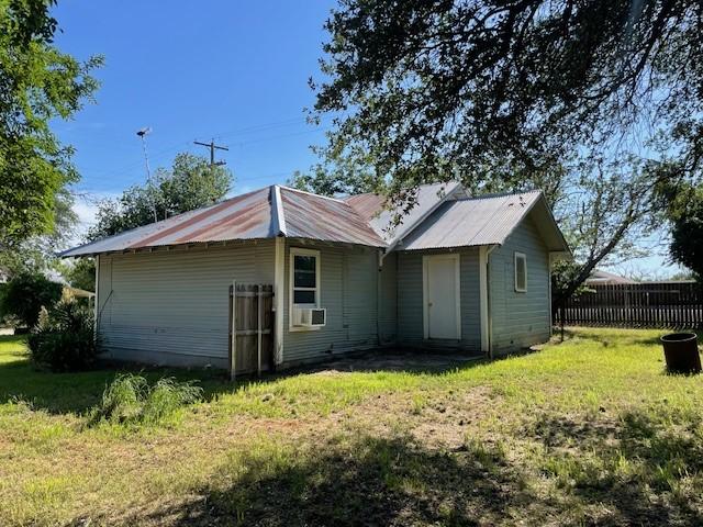 100 E Hill St, Woodson, TX 76491 - back of house featuring metal roof and cooling unit