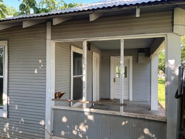 100 E Hill St, Woodson, TX 76491 - view of exterior entry with metal roof and covered porch