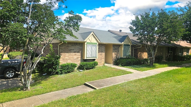 18 E Townhouse Ln Unit 31, Grand Prairie, TX 75052 - view of front of home featuring a front lawn and brick siding