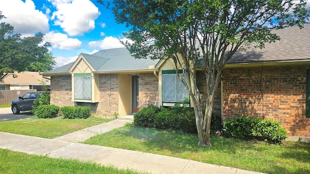18 E Townhouse Ln Unit 31, Grand Prairie, TX 75052 - view of front of house with brick siding and a shingled roof