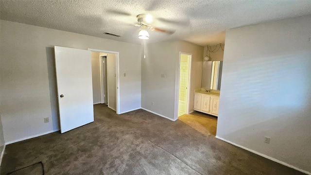 18 E Townhouse Ln Unit 31, Grand Prairie, TX 75052 - unfurnished bedroom with carpet, baseboards, a textured ceiling, ensuite bath, and a ceiling fan