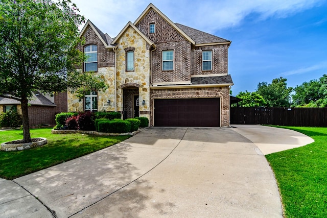 view of front of property featuring brick siding, driveway, an attached garage, and stone siding