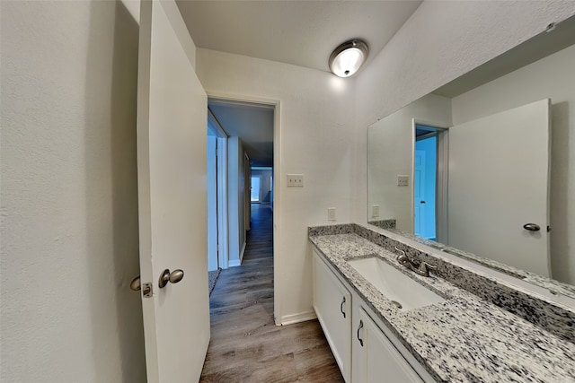 1625 Stockton Trl, Plano, TX 75023 - bathroom featuring wood finished floors, vanity, and baseboards