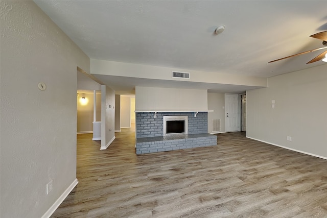 1625 Stockton Trl, Plano, TX 75023 - unfurnished living room with wood finished floors, a ceiling fan, baseboards, and a fireplace