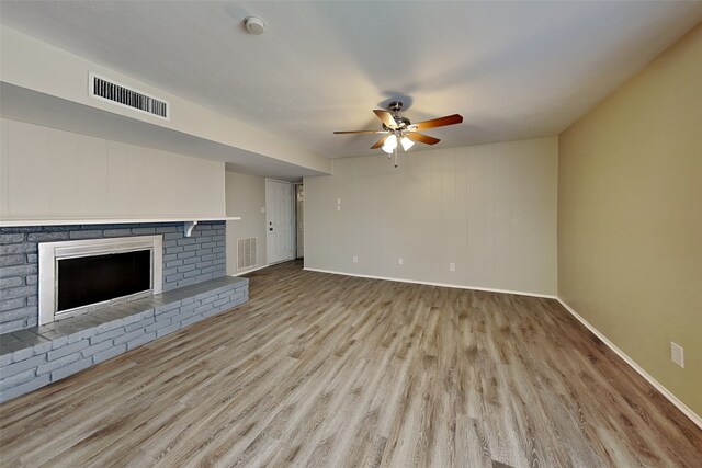 1625 Stockton Trl, Plano, TX 75023 - unfurnished living room with wood finished floors, ceiling fan, baseboards, and a fireplace