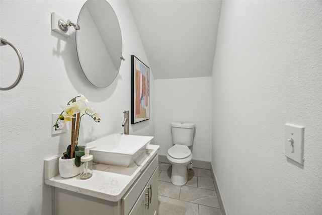 1964 W Davis St, Dallas, TX 75208 - bathroom with vanity, toilet, tile patterned floors, and lofted ceiling