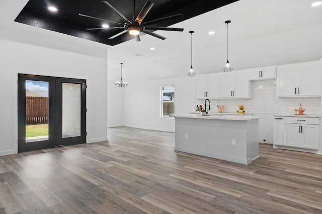 9413 Prairieview Dr, Fort Worth, TX 76134 - kitchen with white cabinetry, light wood-style flooring, recessed lighting, backsplash, and decorative light fixtures