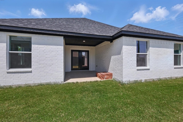 9413 Prairieview Dr, Fort Worth, TX 76134 - property entrance featuring roof with shingles, a yard, and brick siding
