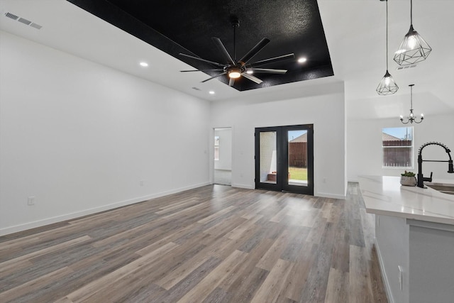 9413 Prairieview Dr, Fort Worth, TX 76134 - unfurnished living room with a sink, wood finished floors, a chandelier, a ceiling fan, and recessed lighting