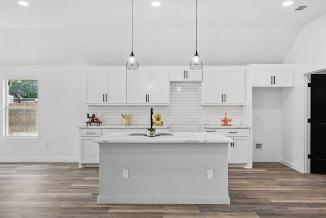 9413 Prairieview Dr, Fort Worth, TX 76134 - kitchen with a sink, vaulted ceiling, white cabinetry, backsplash, and pendant lighting