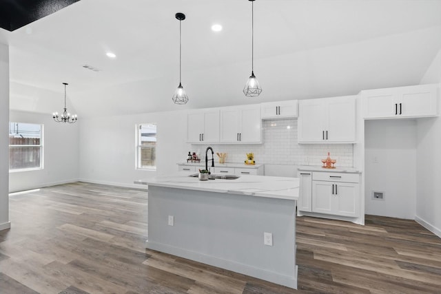 9413 Prairieview Dr, Fort Worth, TX 76134 - kitchen with a sink, lofted ceiling, white cabinetry, backsplash, and wood finished floors