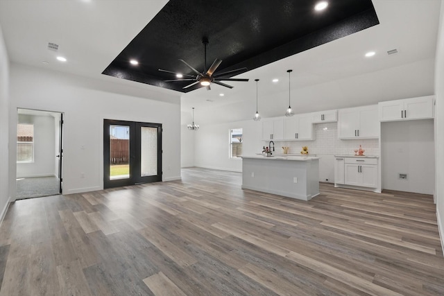 9413 Prairieview Dr, Fort Worth, TX 76134 - living area with ceiling fan, recessed lighting, light wood-style flooring, a towering ceiling, and a chandelier