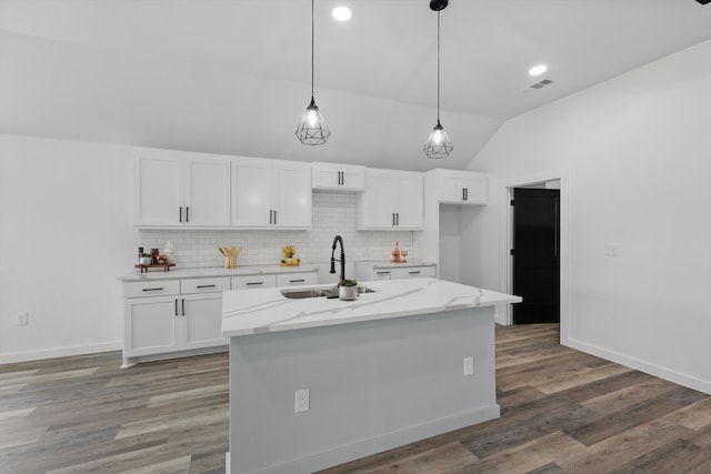 9413 Prairieview Dr, Fort Worth, TX 76134 - kitchen with a sink, vaulted ceiling, white cabinetry, backsplash, and decorative light fixtures