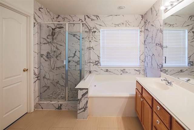 full bath featuring a bath, a marble finish shower, and vanity