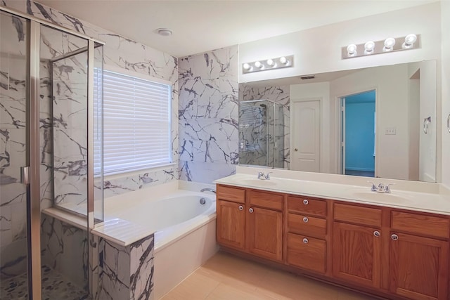 full bathroom featuring a marble finish shower, a bath, double vanity, and tile patterned floors