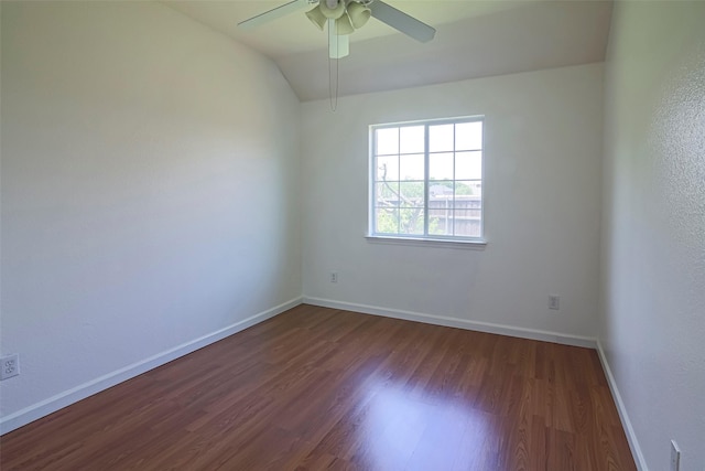 spare room with dark wood finished floors, baseboards, ceiling fan, and lofted ceiling