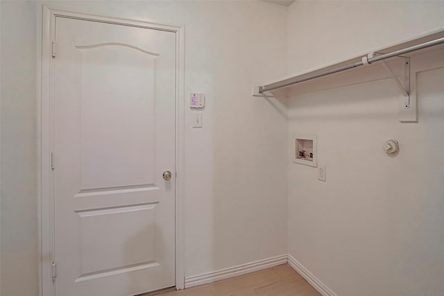 washroom featuring hookup for a washing machine, baseboards, light wood-type flooring, and hookup for a gas dryer