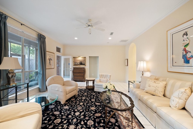 living room with arched walkways, ceiling fan, ornamental molding, and recessed lighting