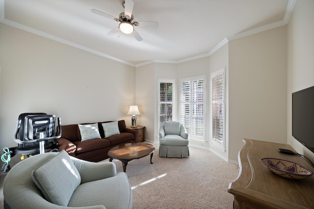 carpeted living room featuring baseboards, crown molding, and a ceiling fan