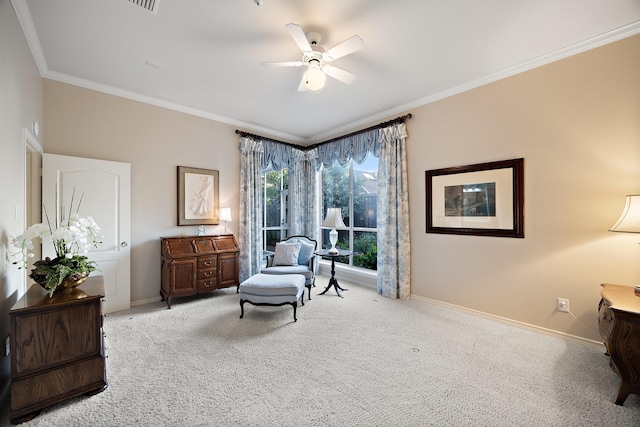 sitting room featuring baseboards, ceiling fan, ornamental molding, and carpet floors