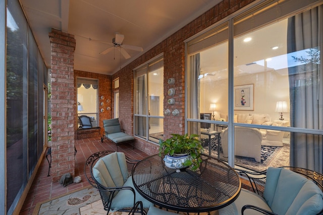 sunroom / solarium featuring ceiling fan
