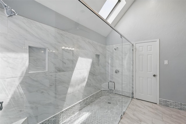 bathroom featuring a stall shower and marble look tile flooring