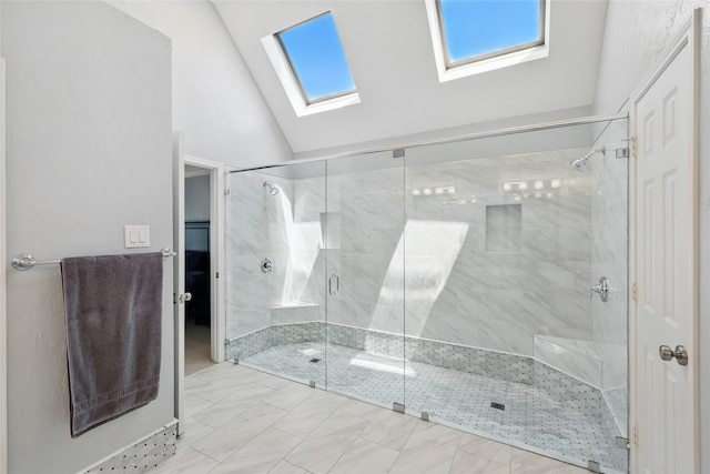 full bath featuring a skylight, vaulted ceiling, and a stall shower
