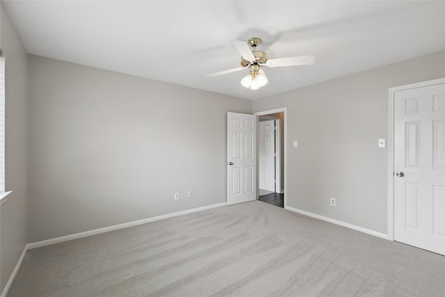 unfurnished bedroom featuring carpet, baseboards, and a ceiling fan