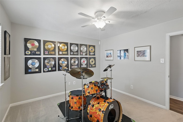 game room featuring carpet floors, ceiling fan, and baseboards
