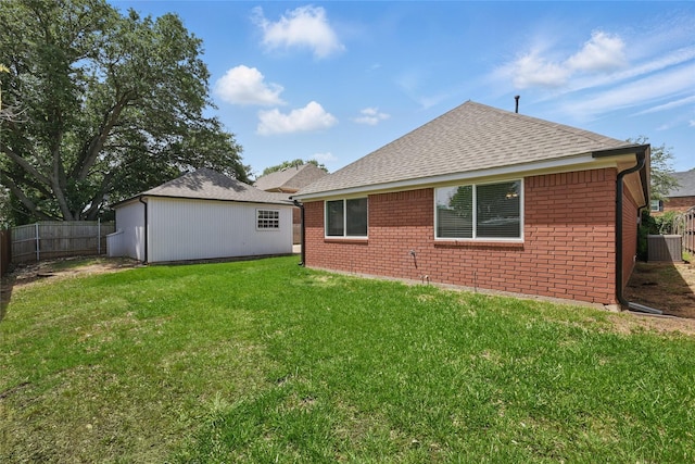 rear view of house with brick siding and roof with shingles