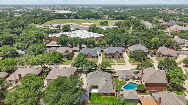 view of property location with nearby suburban area and a pool area