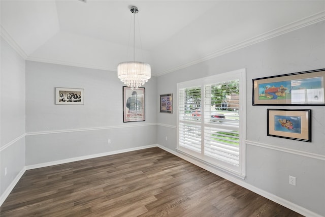 unfurnished dining area with wood finished floors, a chandelier, ornamental molding, baseboards, and a tray ceiling