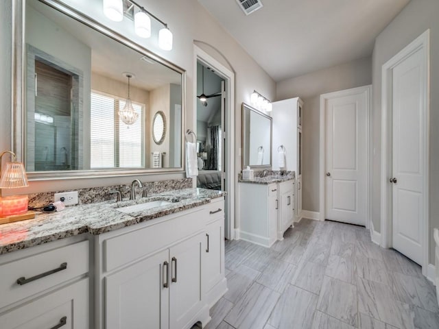 6209 Crystal Cove Ct, Mckinney, TX 75071 - full bath featuring two vanities, a stall shower, and a chandelier
