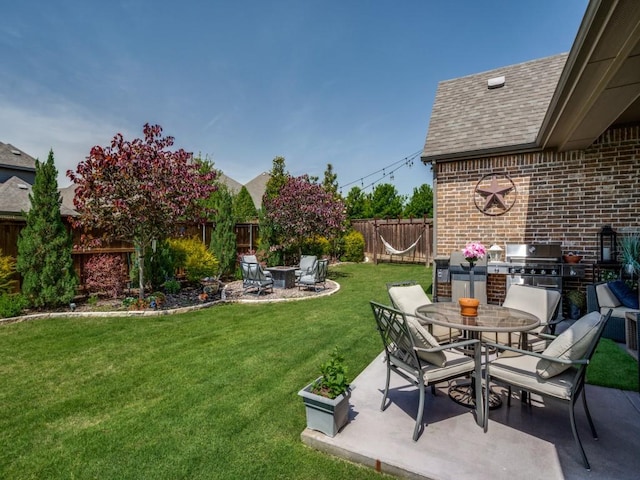 6209 Crystal Cove Ct, Mckinney, TX 75071 - view of yard with exterior kitchen, a patio, outdoor dining space, and a fire pit