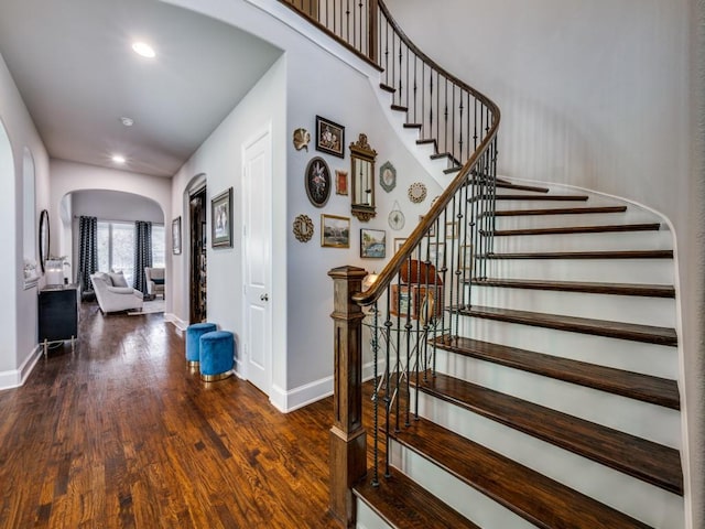 6209 Crystal Cove Ct, Mckinney, TX 75071 - stairway featuring arched walkways, baseboards, wood finished floors, and recessed lighting