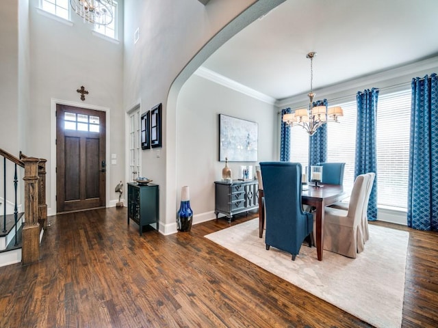 6209 Crystal Cove Ct, Mckinney, TX 75071 - dining space featuring a chandelier, arched walkways, wood finished floors, stairway, and ornamental molding