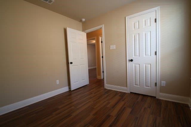 8036 Doreen Ave, Fort Worth, TX 76116 - unfurnished bedroom featuring dark wood-style floors and baseboards