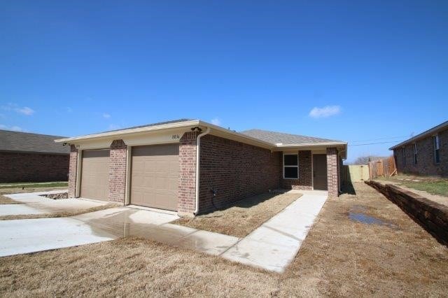 8036 Doreen Ave, Fort Worth, TX 76116 - view of home's exterior featuring an attached garage, fence, and brick siding