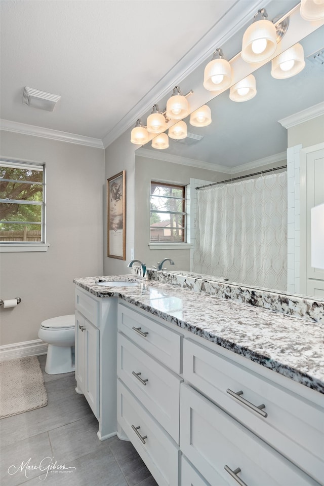 5730 Lovers Ln, Shreveport, LA 71105 - full bath with toilet, vanity, plenty of natural light, crown molding, and baseboards