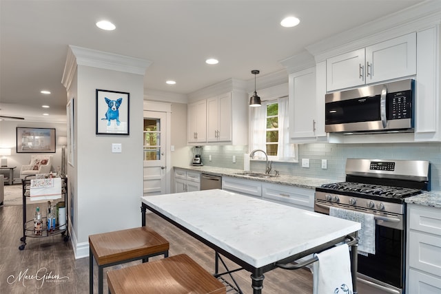 5730 Lovers Ln, Shreveport, LA 71105 - kitchen with appliances with stainless steel finishes, a sink, ornamental molding, white cabinetry, and backsplash