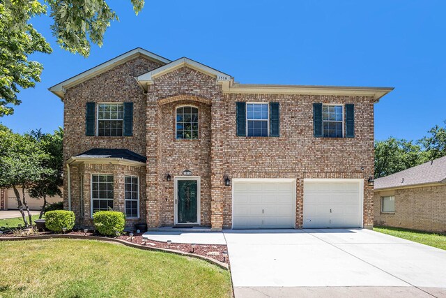 1516 Cheyenne Trl, Mansfield, TX 76063 - traditional home featuring driveway, brick siding, an attached garage, and a front lawn