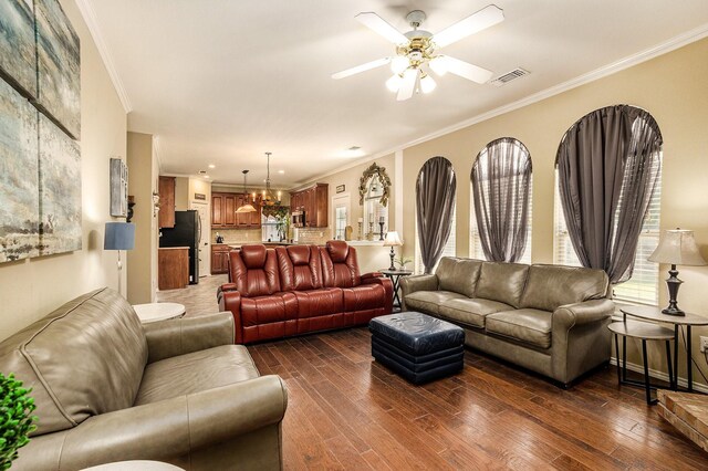 1516 Cheyenne Trl, Mansfield, TX 76063 - living room featuring ornamental molding, dark wood-style flooring, a ceiling fan, and a chandelier