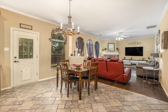 1516 Cheyenne Trl, Mansfield, TX 76063 - dining space with ceiling fan, stone tile flooring, ornamental molding, a chandelier, and baseboards